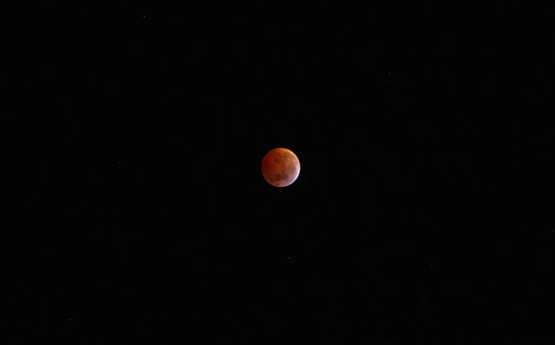 the full moon in the sky, with a dark sky background