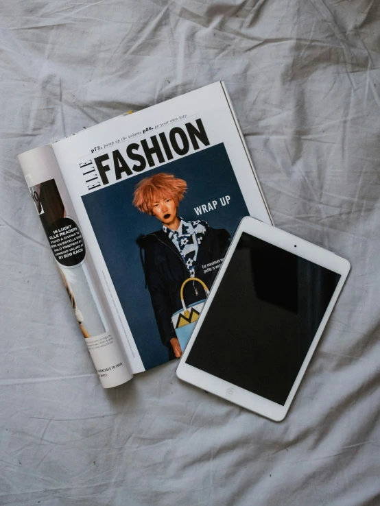 a magazine with a fashion cover and tablet pc