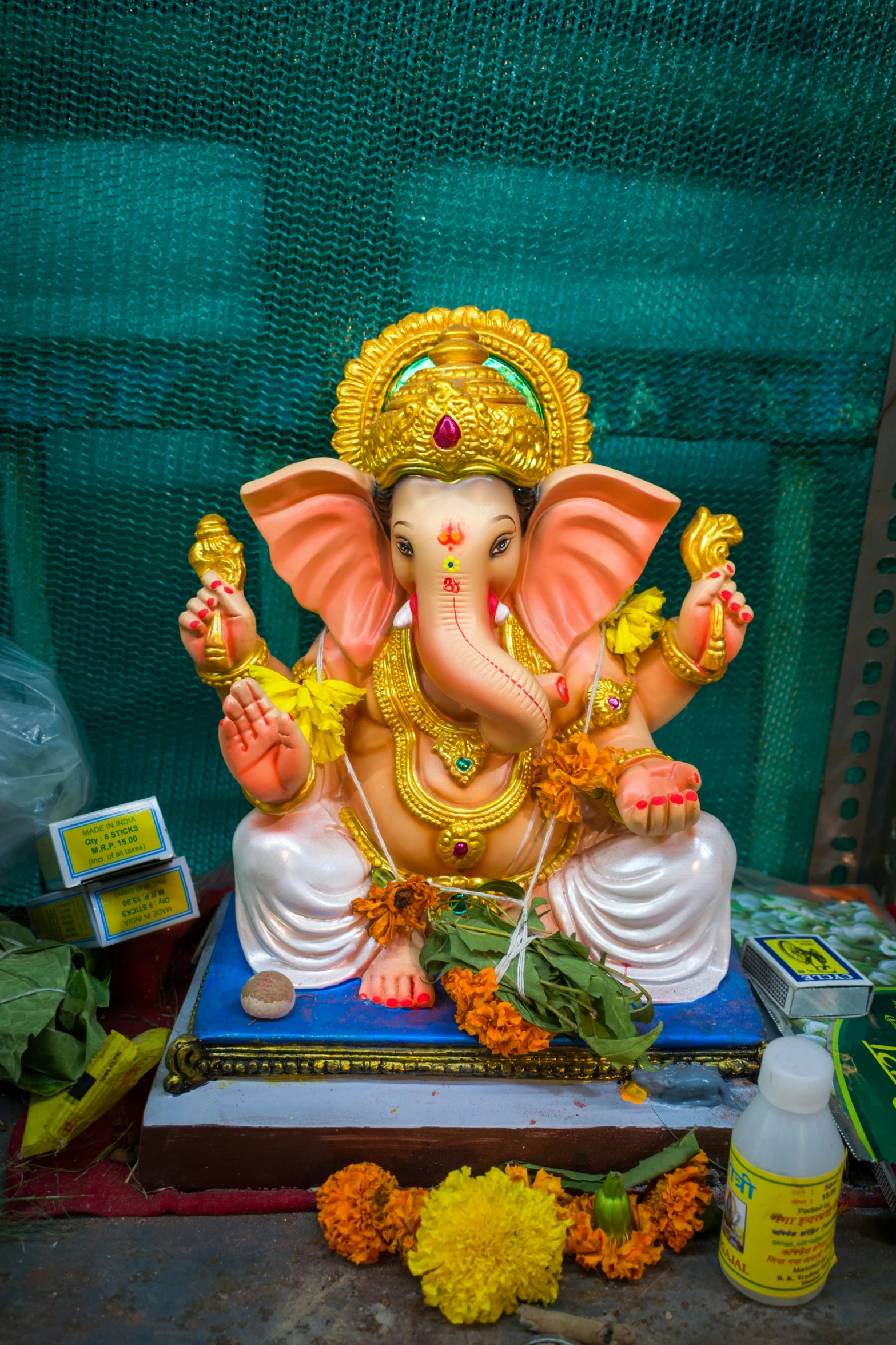 an elephant statue next to a pile of flowers