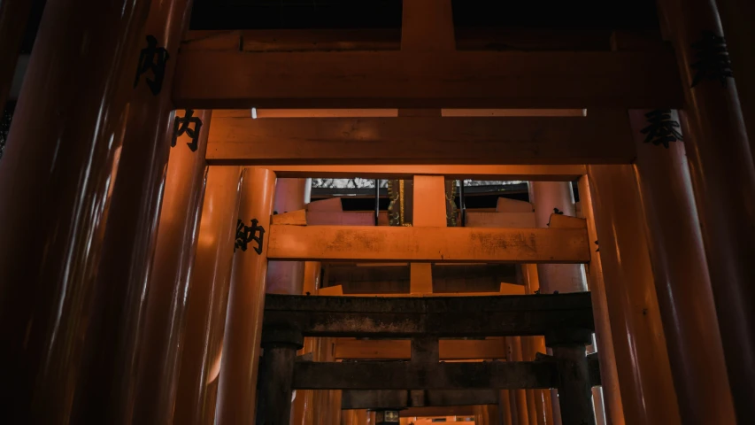 an oriental looking structure with orange columns and lights