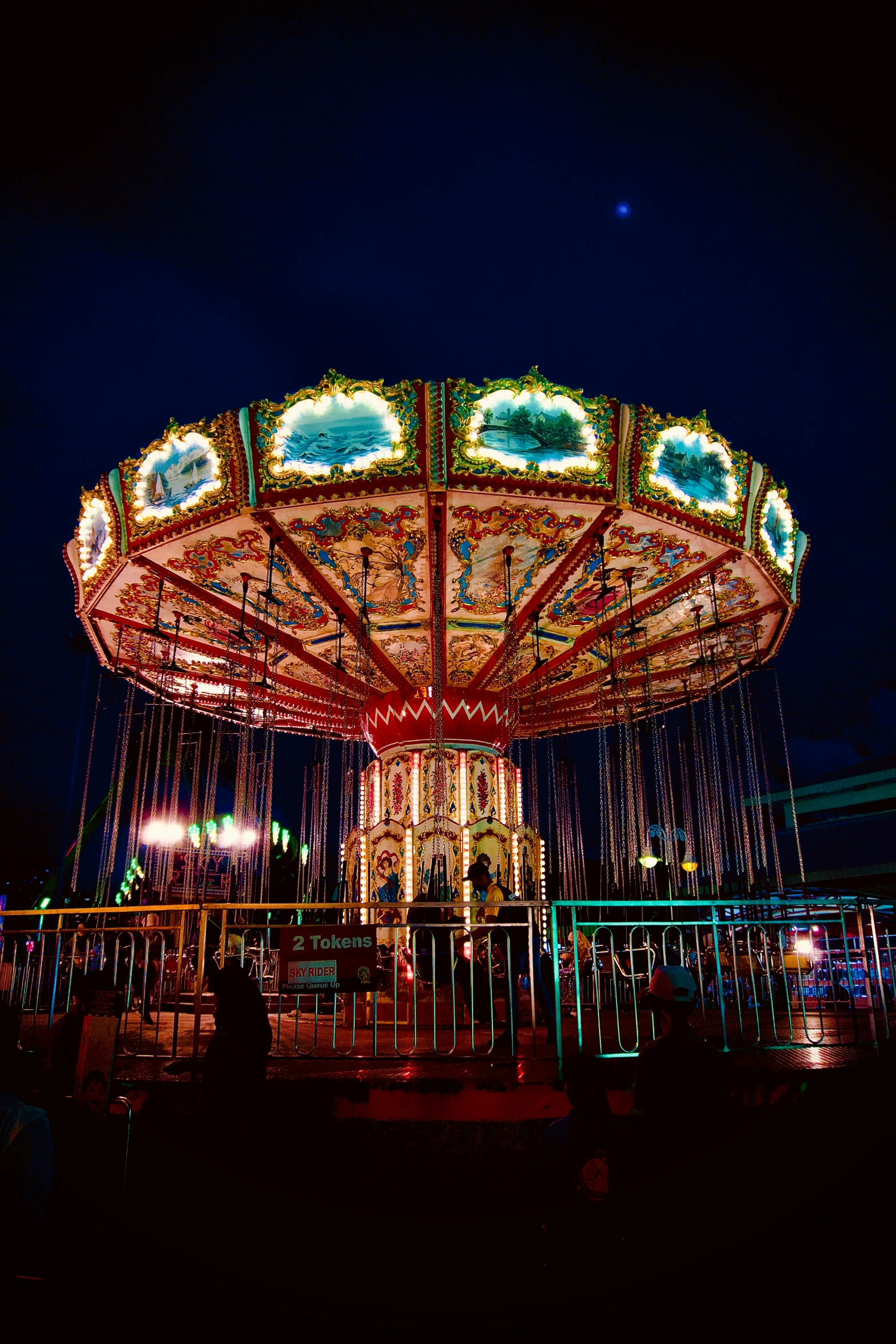 a merry go round with lights in a city park