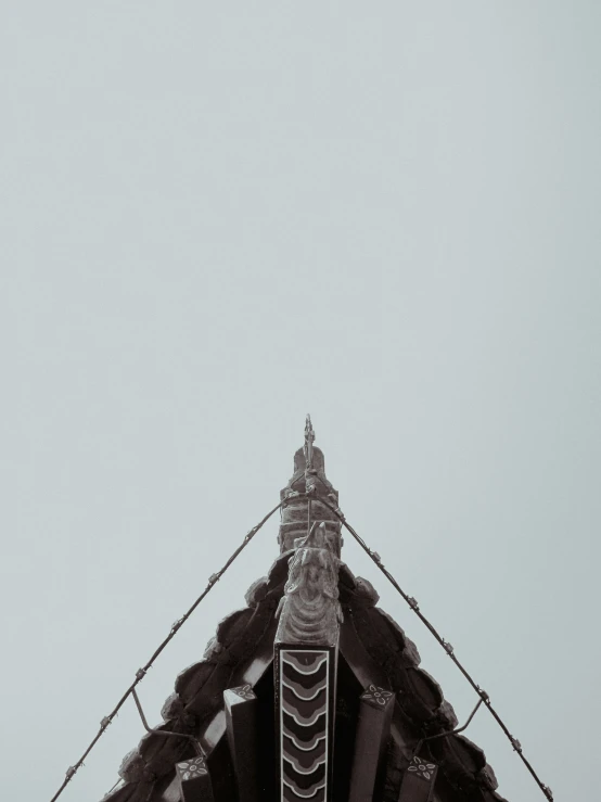 an airplane flying in the sky over an old structure