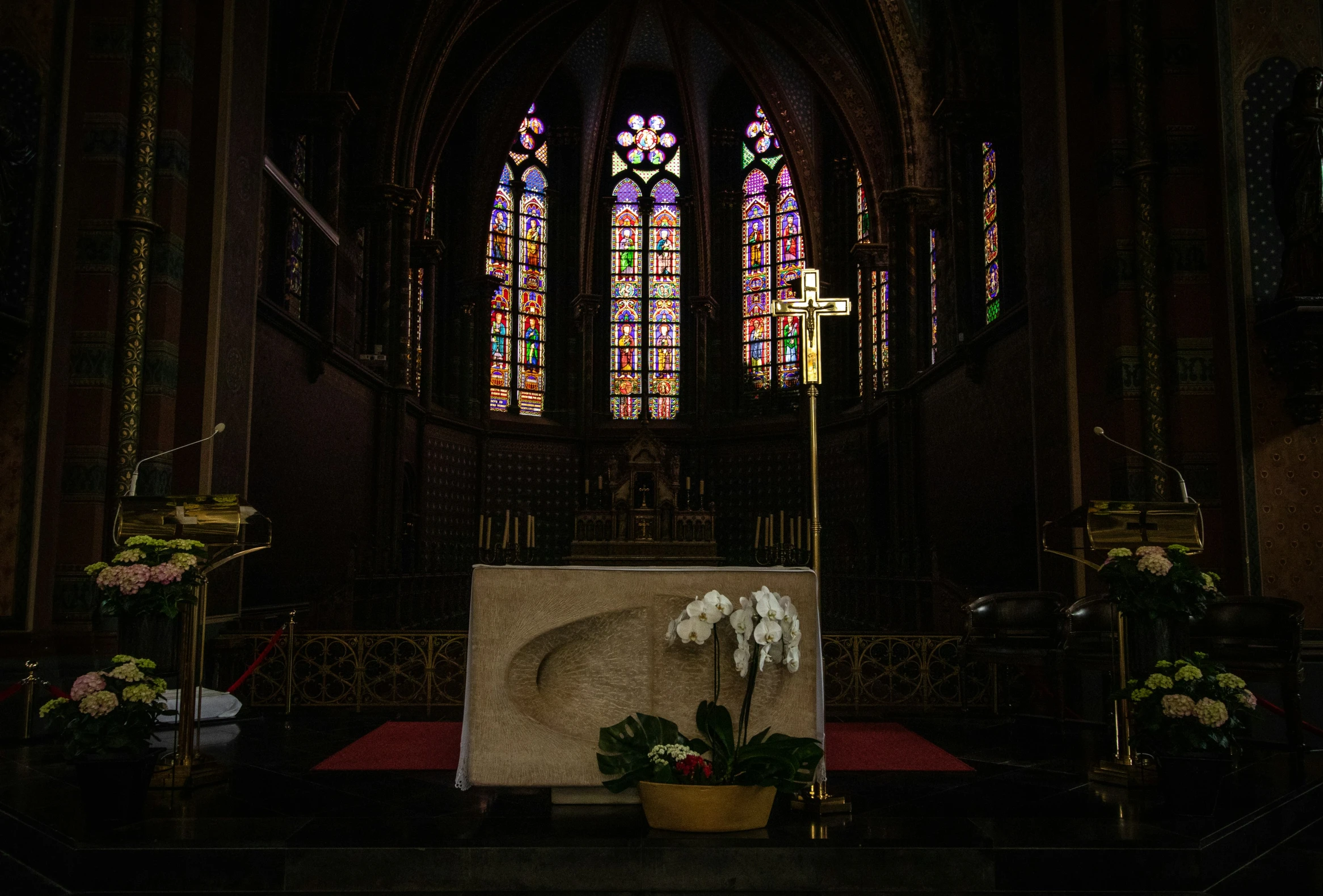 a church with a big window and a tall altar