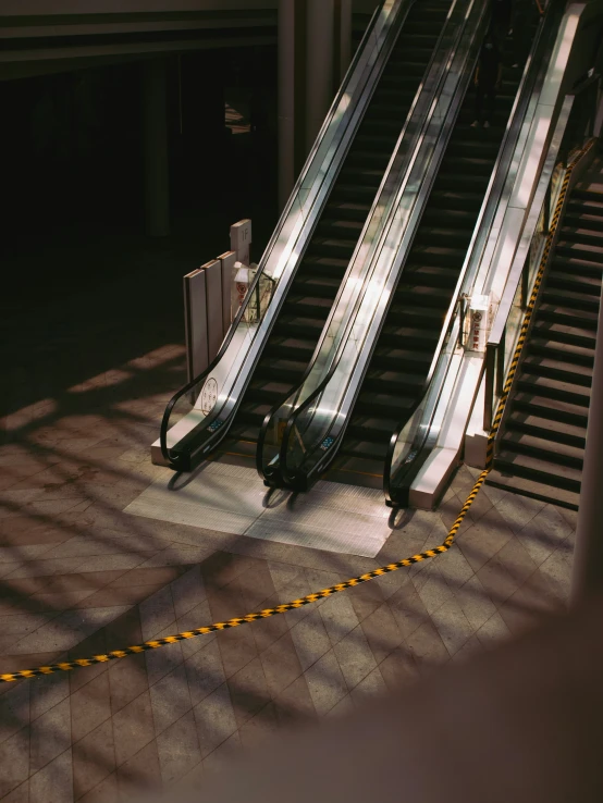 two escalators sitting on top of a tiled floor