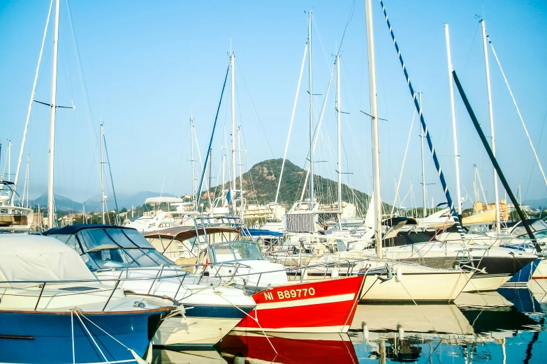 several boats sit in the water next to each other