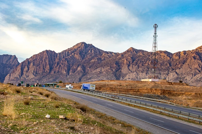 the mountains are beyond the highway going in to nowhere