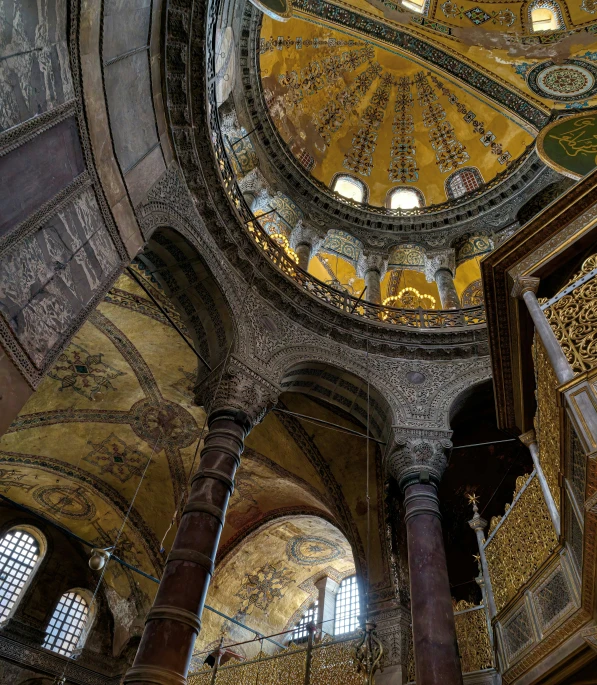 a golden and black dome has four pillars