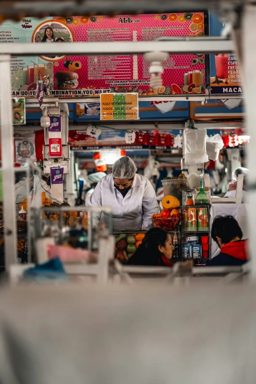 a view from behind a counter top that has a woman and boy in it