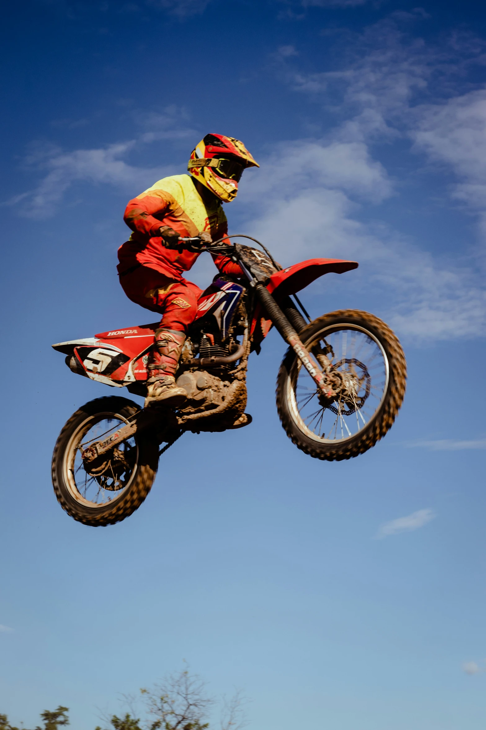 a man in the air on top of a dirt bike