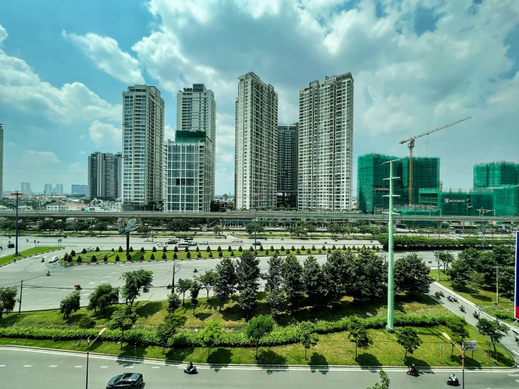 several large buildings with green grass around them