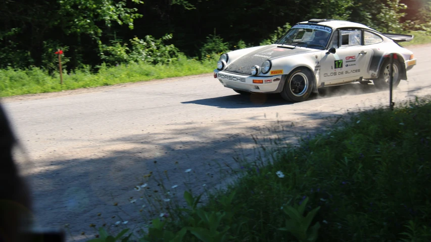 the porsche 907 rally car is traveling down the road