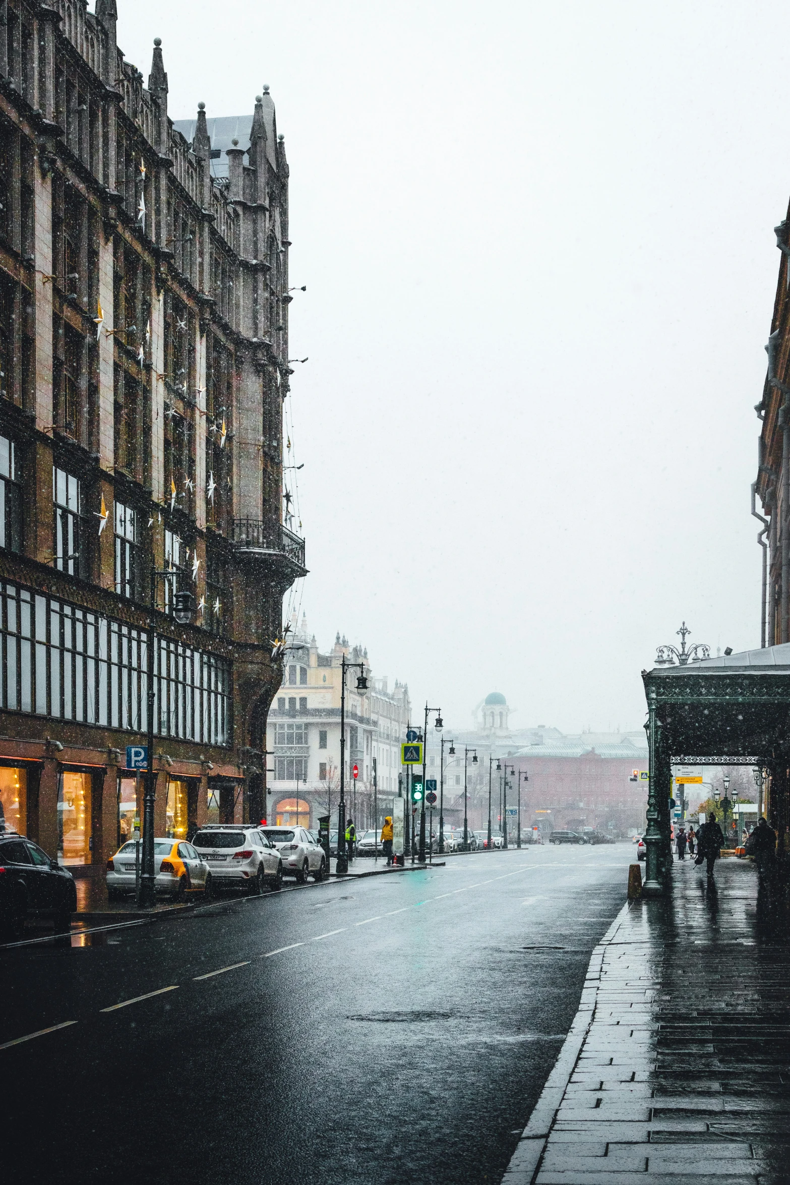 a city street that has a rain soaked sidewalk