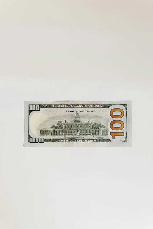 the 50 dollar bill is placed against a wall