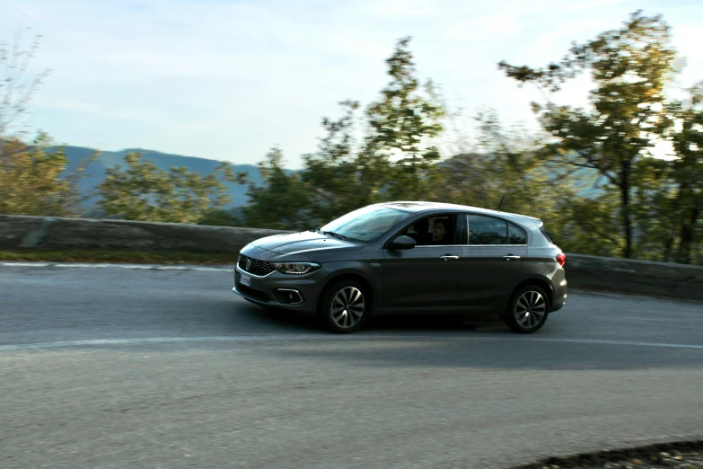 a black suv driving down a winding road