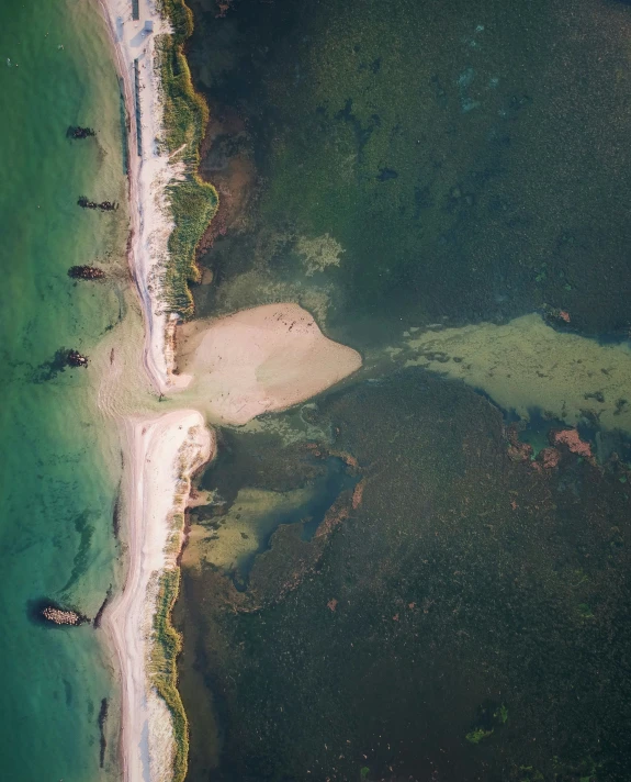 a beach that has some small rocks and sand in it