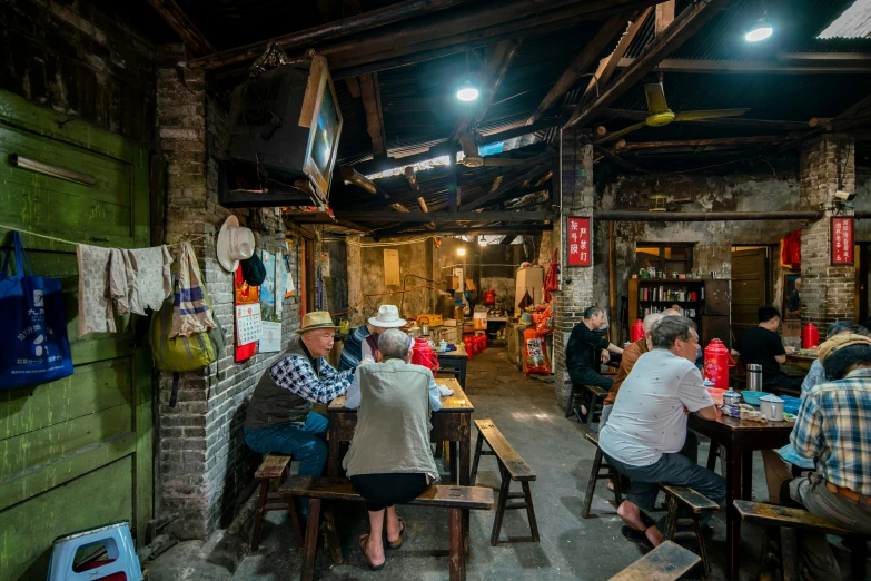 people eating in a small restaurant with tables