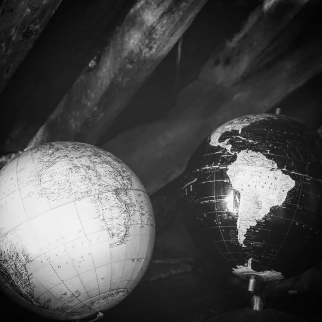 black and white globes in front of wood planks