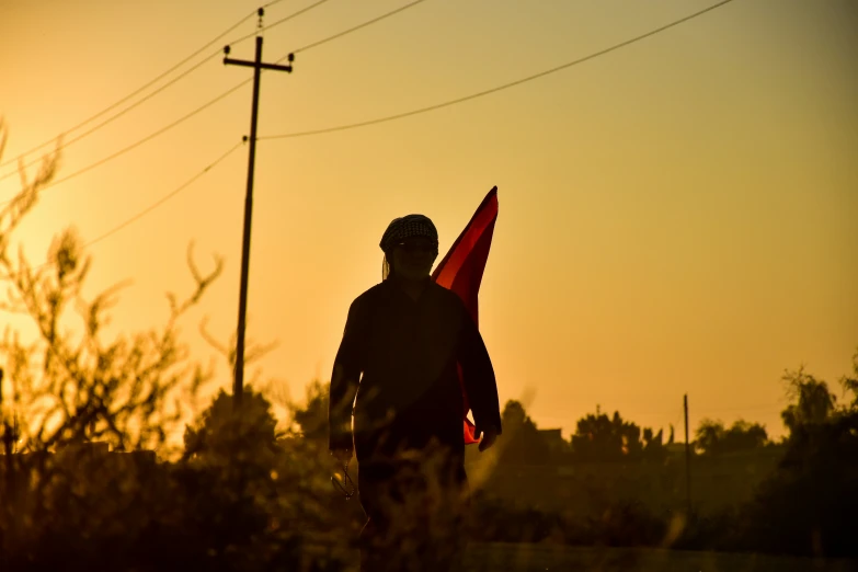 a man is carrying two flags in his hand