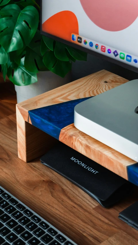 an apple computer sitting on top of a wooden table