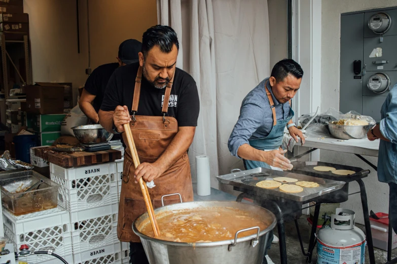 two men making a meal in a kitchen