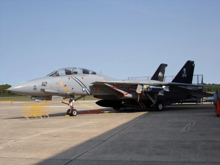 a fighter jet sitting on top of an airport tarmac