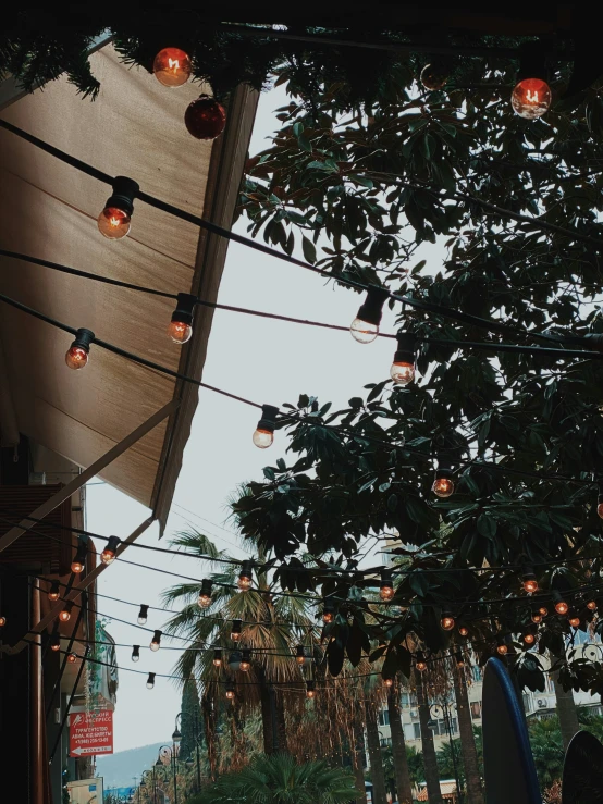 several lights hanging from a canopy and in the shade