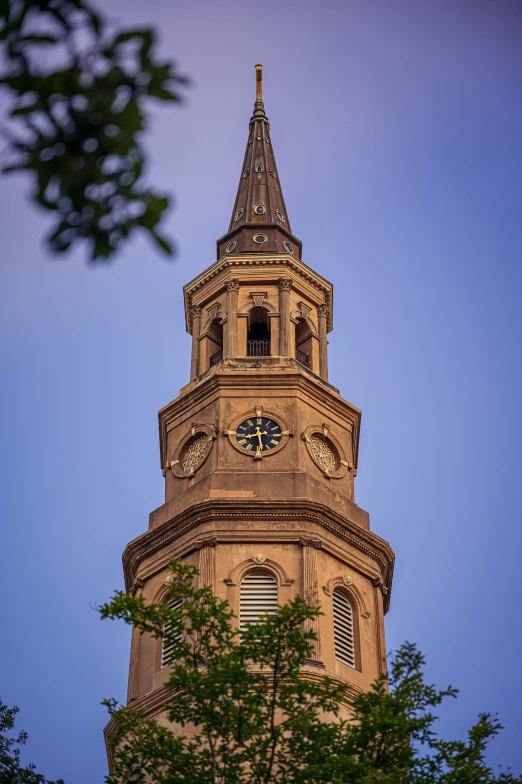 a very tall church tower with clocks at the top