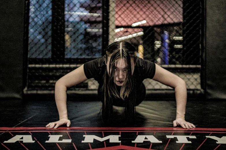 a woman is holding her head while lying on a floor