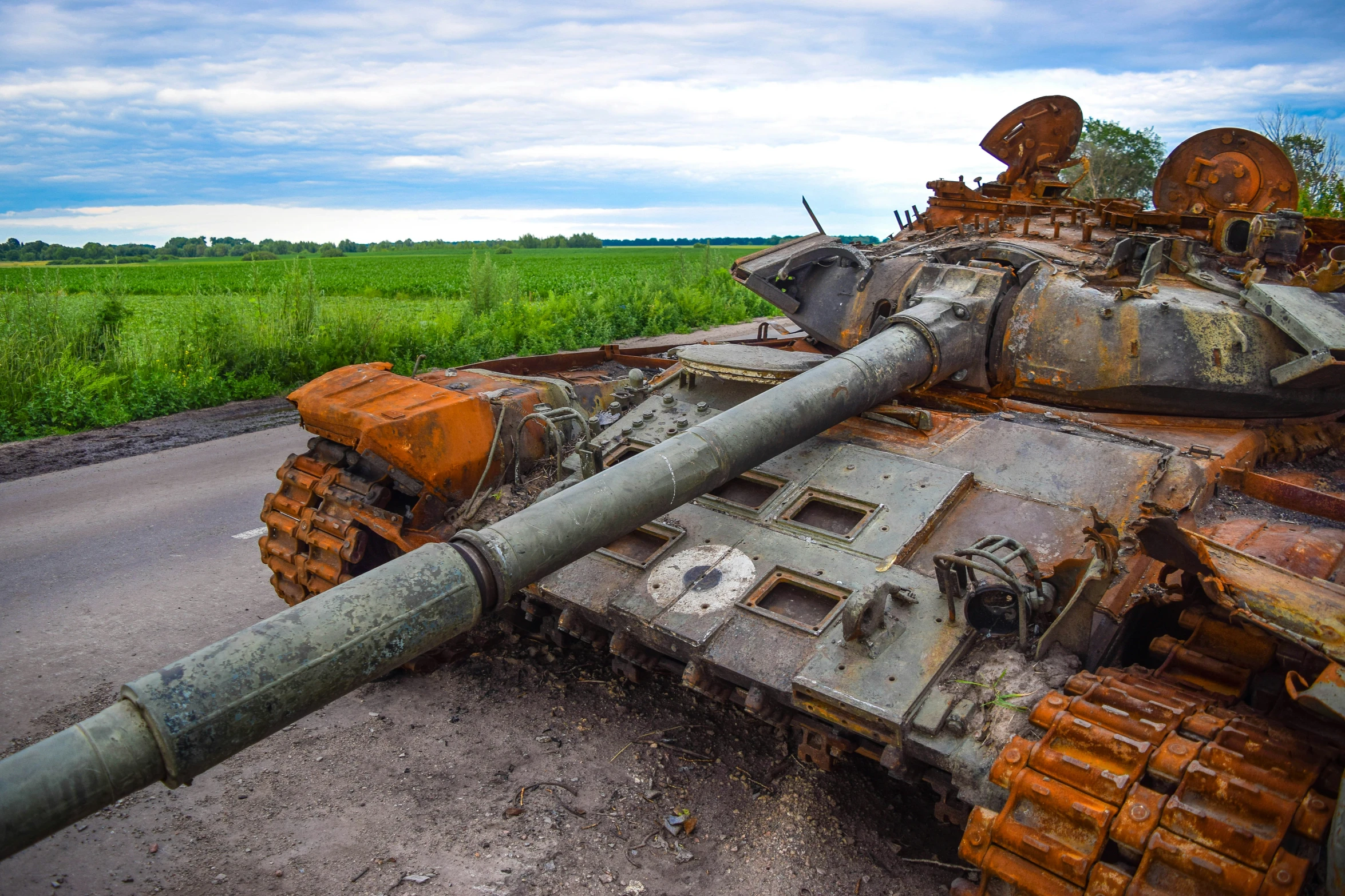 an old rusted tank sitting in the middle of a field