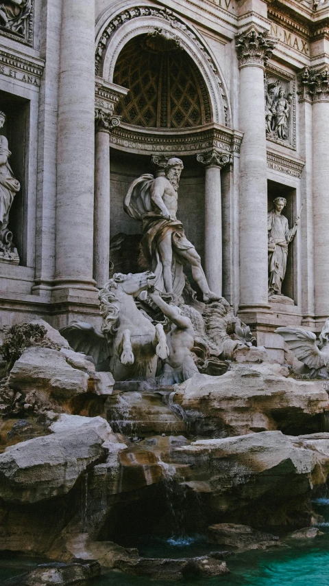 a man sitting on top of a sculpture near a building