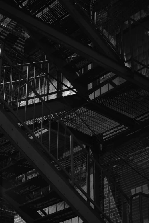 looking down at the underside of a metal staircase