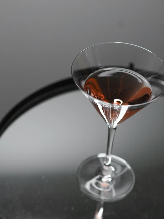 a martini glass filled with wine next to a bar