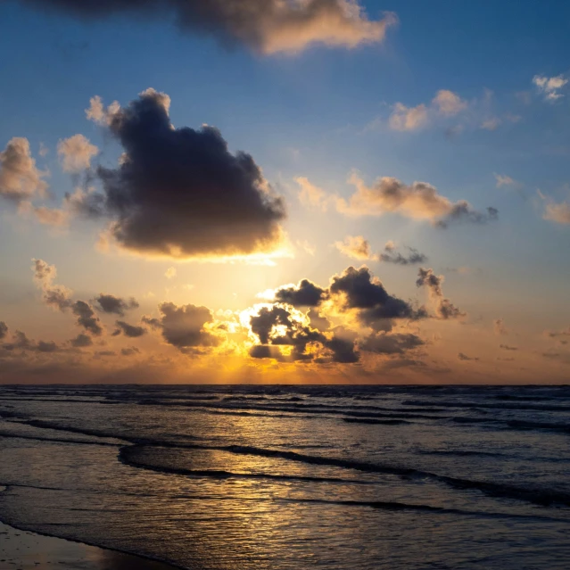 sun setting with dark clouds in the sky