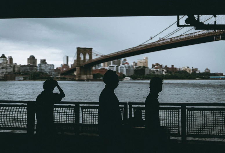 a group of people that are standing by a river