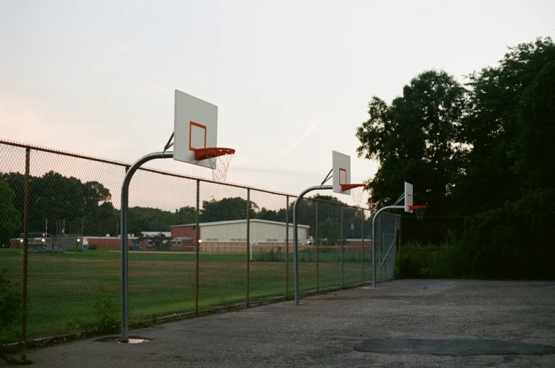 basketball goal in an empty playground with grass