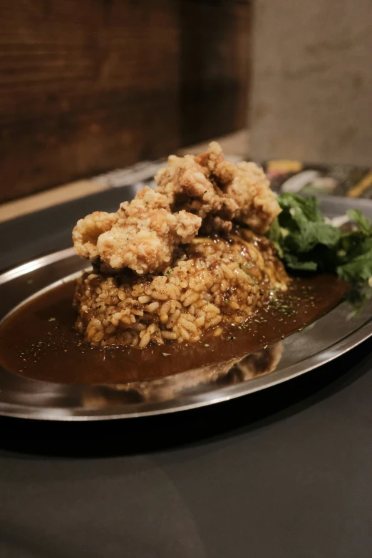 a dish with rice on top and vegetables