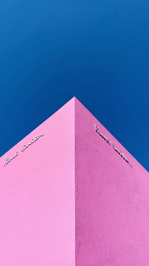 a pink colored structure and the blue sky in the background