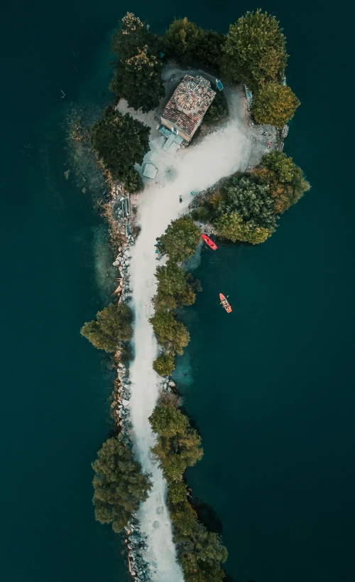 this aerial view shows a path on the water by a house