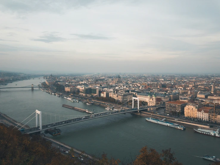 a bird eye view of a bridge, river and buildings