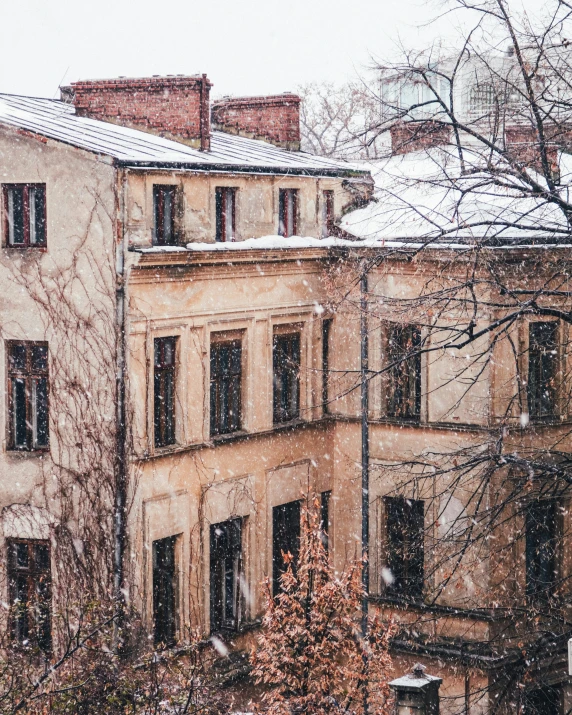 a snowy day outside an apartment building looking down at some snow