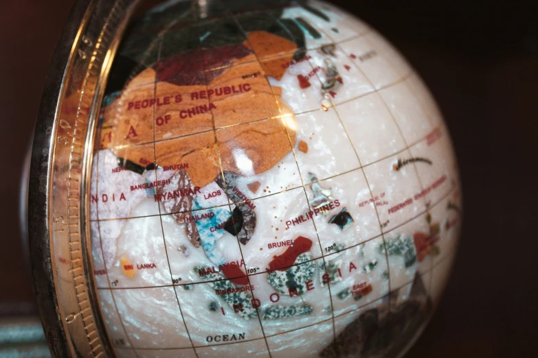 a globe with maps drawn on it sits on the shelf