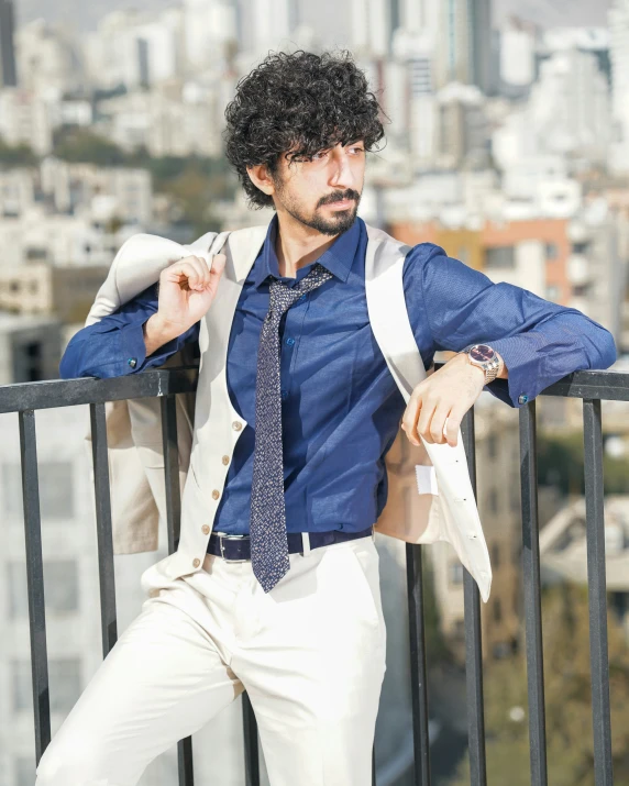 the man is posing for a po while posing on the balcony