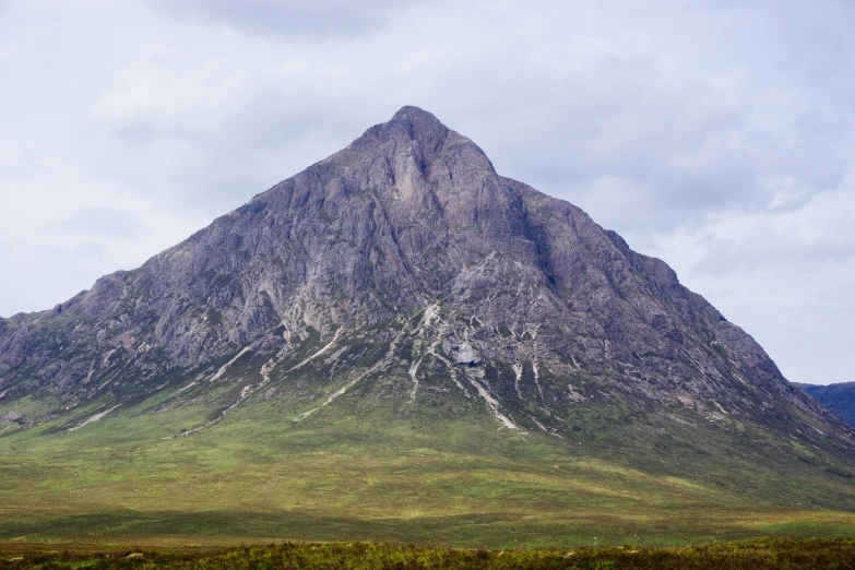 a large mountain rising above the forest of trees