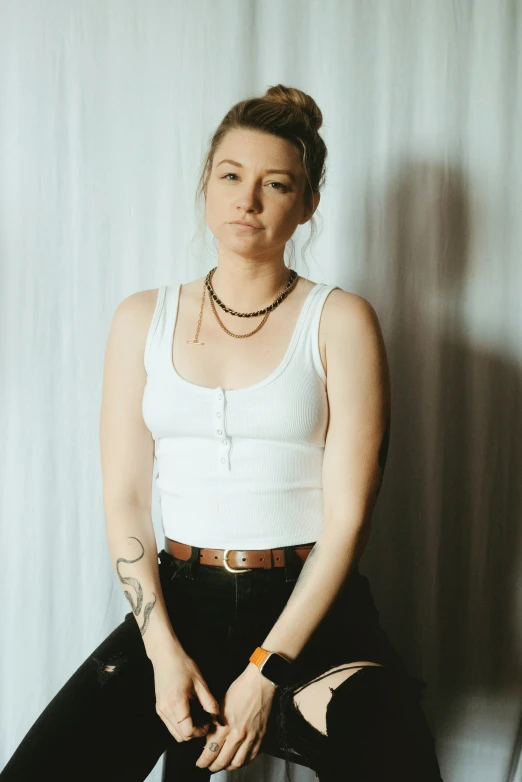 a woman posing in front of a white background