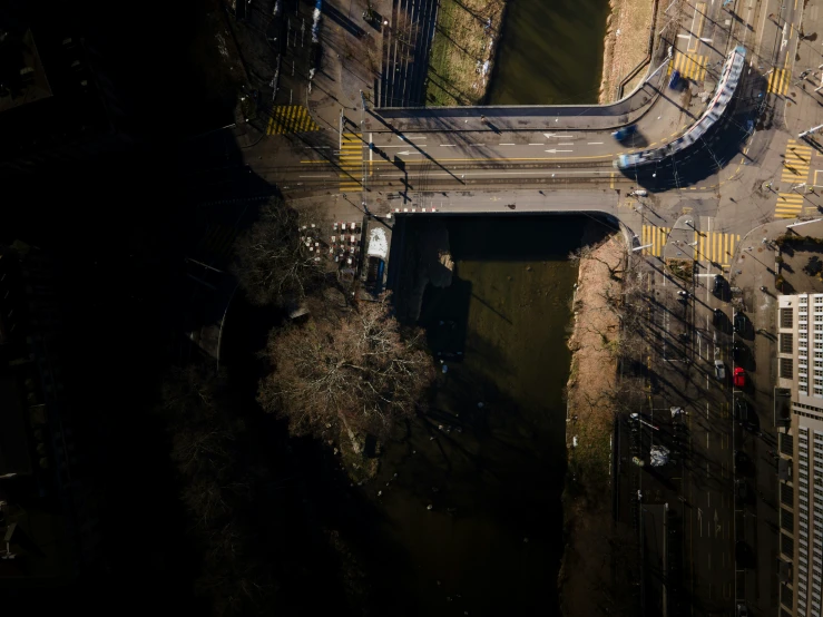 an overhead view of a bus and cars driving across a street