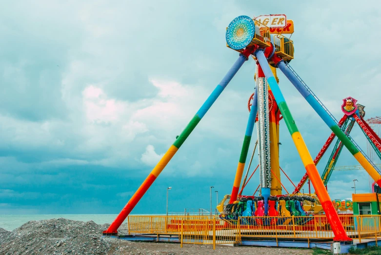 a colorful carnival ride in a dark cloudy sky