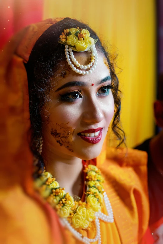 indian woman in bridal attire with a necklace and earrings