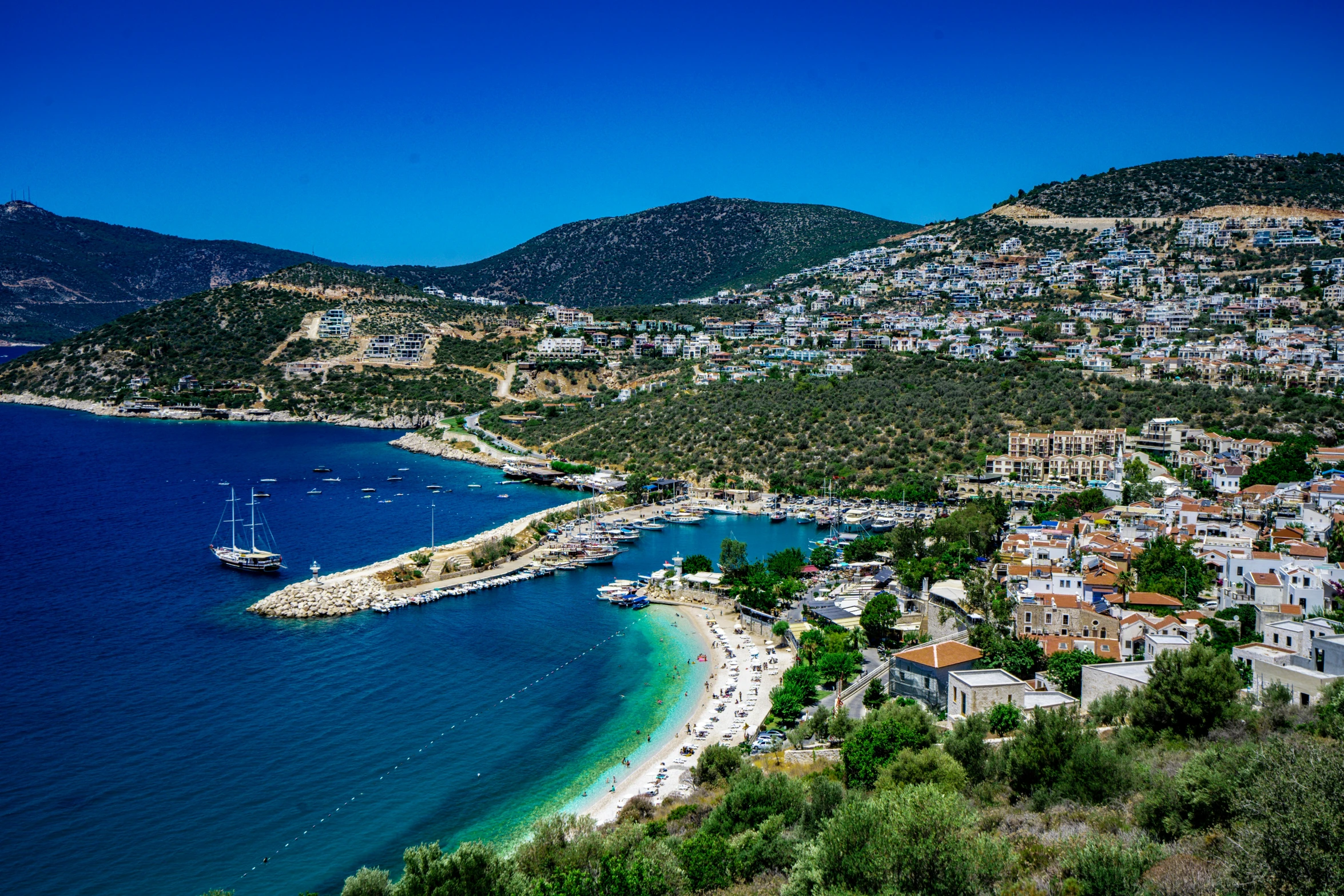 the town is on the shore of the water and there are lots of houses on it