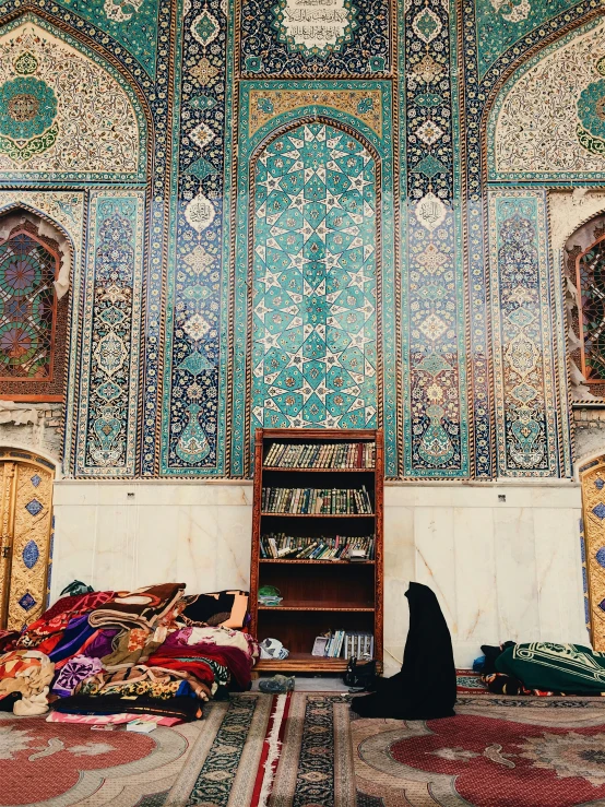 a room full of rugs and a book shelf