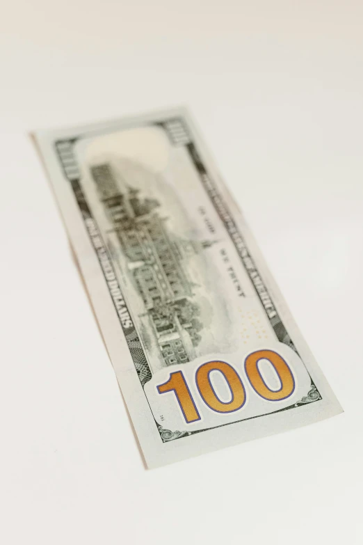 a $ 100 bill is laying on the counter